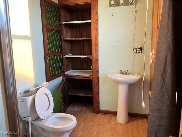 bathroom featuring hardwood / wood-style floors and toilet