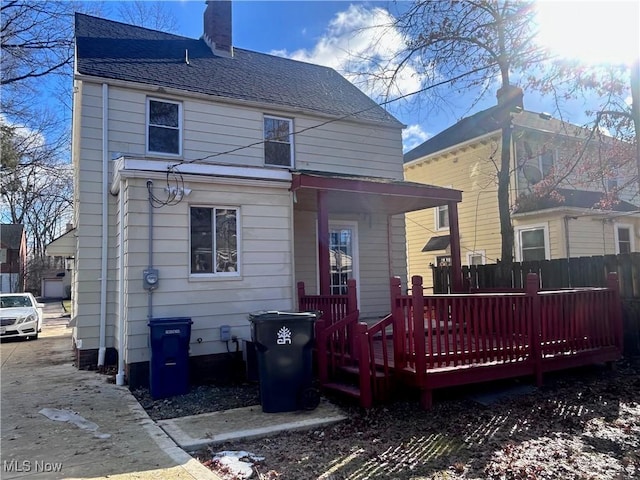 rear view of property featuring a deck