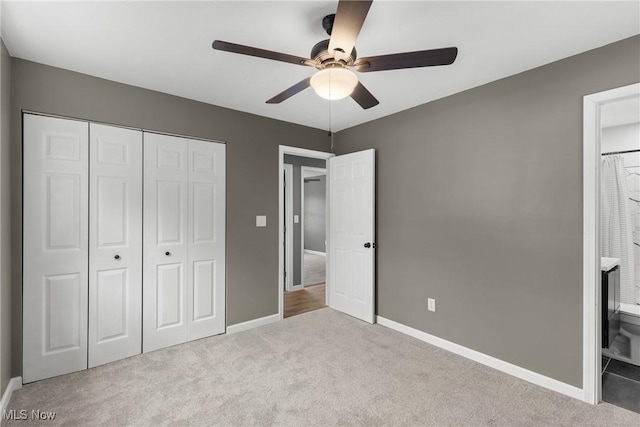 unfurnished bedroom with light colored carpet, a closet, and ceiling fan