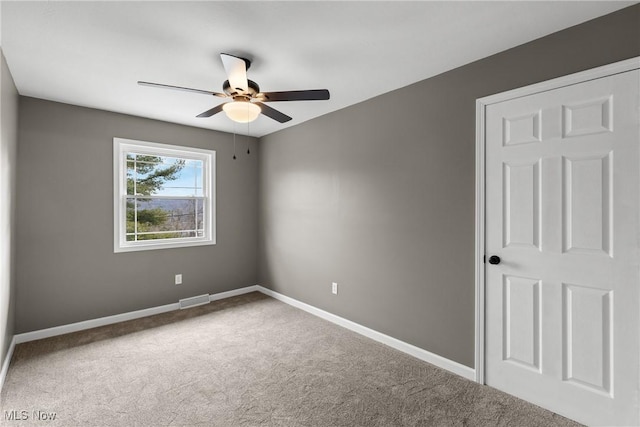 unfurnished room with ceiling fan and carpet flooring