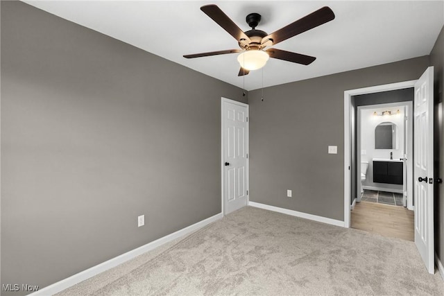 unfurnished bedroom with light colored carpet and ceiling fan