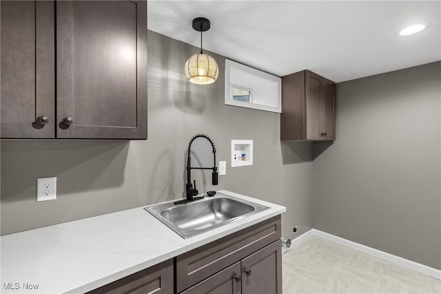 kitchen with sink, decorative light fixtures, and dark brown cabinets