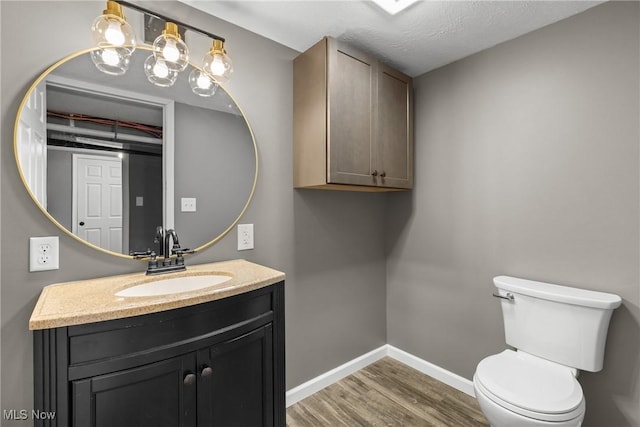 bathroom featuring hardwood / wood-style flooring, vanity, and toilet