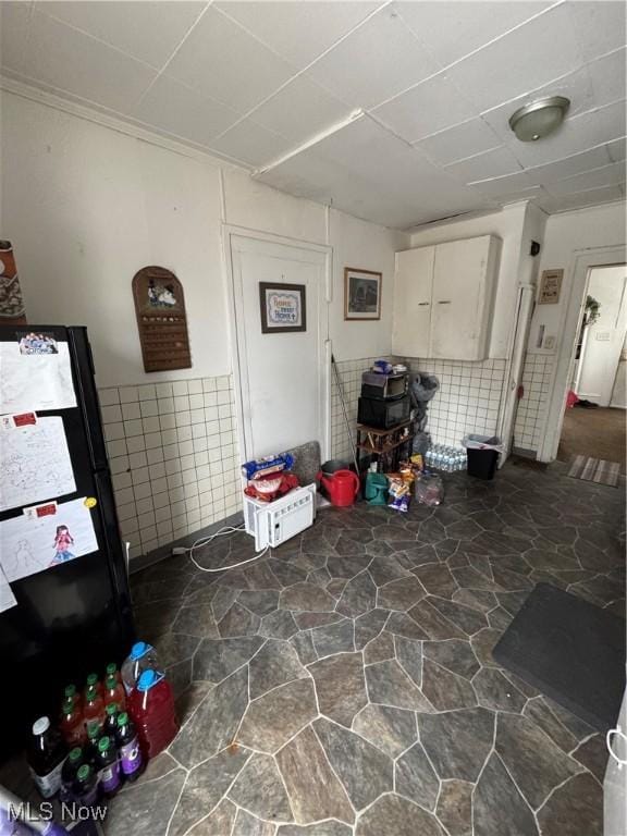 basement with black refrigerator