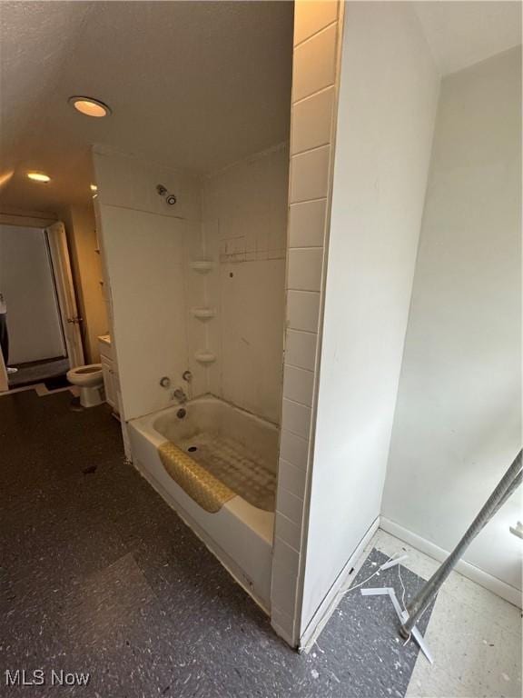 bathroom with washtub / shower combination and toilet