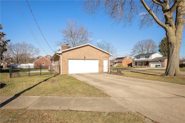 view of side of property with a garage and a lawn