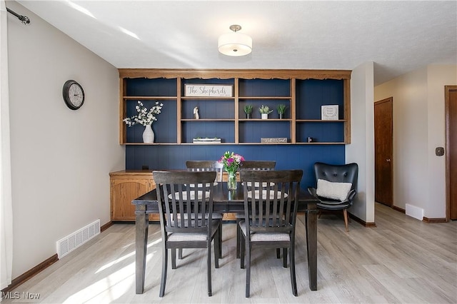 dining area with wood-type flooring