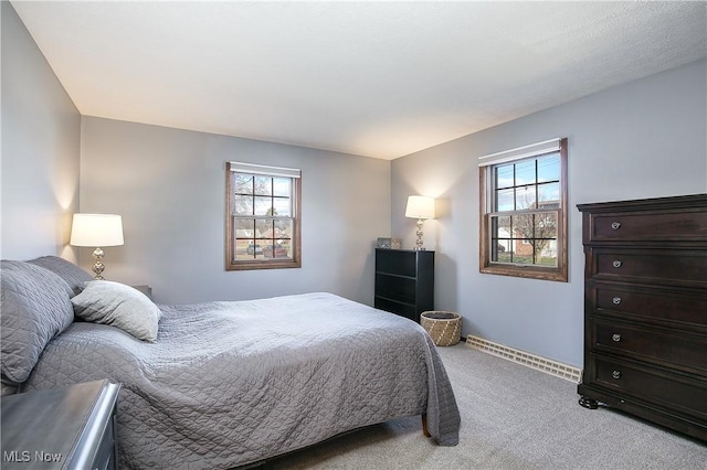 bedroom featuring multiple windows and light colored carpet