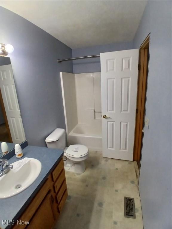 full bathroom with vanity, shower / bathtub combination, and toilet