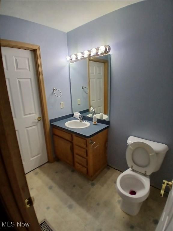 bathroom with vanity and toilet