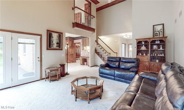 living room featuring light colored carpet and a towering ceiling