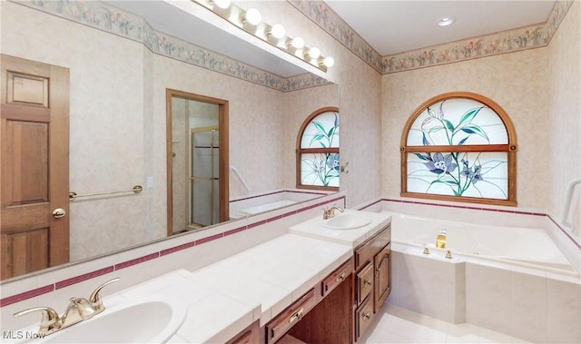 bathroom with vanity and shower with separate bathtub