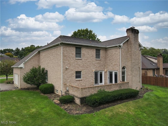 view of side of property featuring a yard and a garage