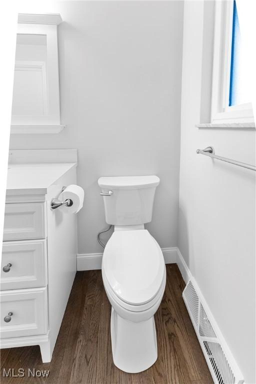 bathroom with hardwood / wood-style flooring and toilet