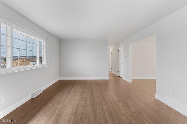 unfurnished room with hardwood / wood-style flooring