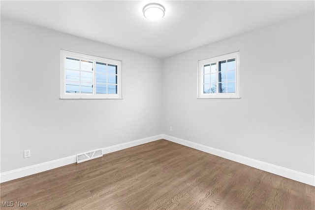 empty room with hardwood / wood-style flooring