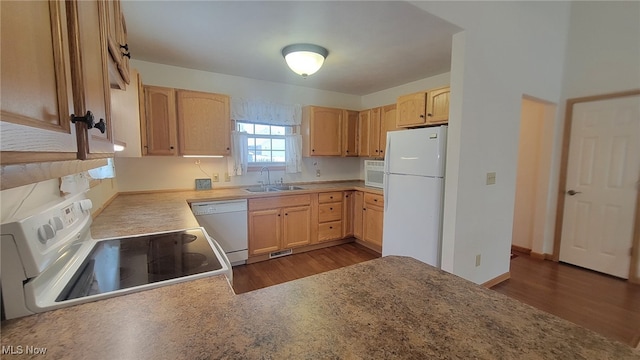 kitchen with light brown cabinetry, sink, and white appliances