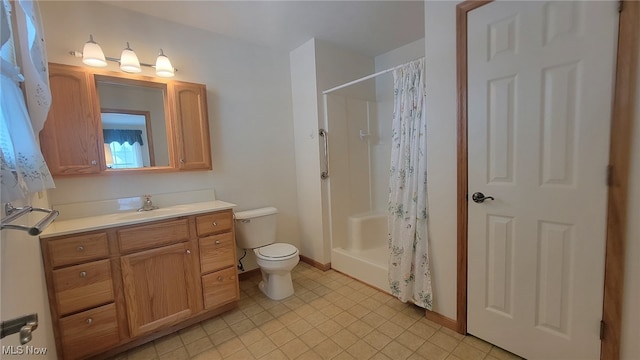 bathroom featuring vanity, toilet, and walk in shower