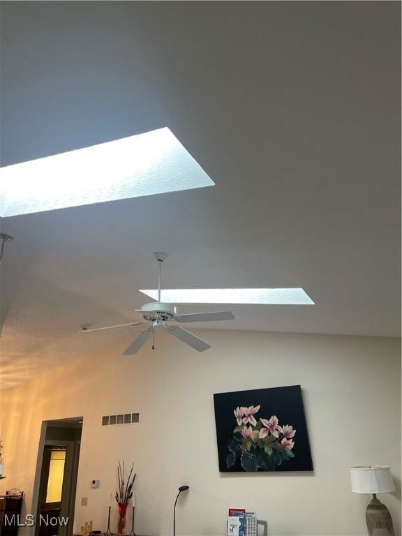 interior details with visible vents, a ceiling fan, and a skylight