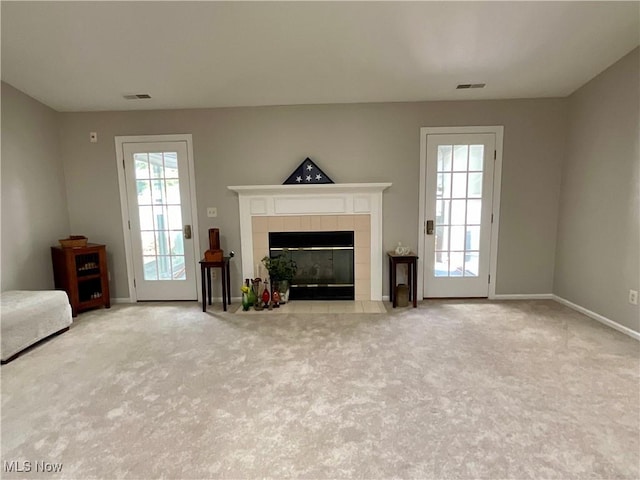 721 Winding Way, Akron, OH 44313 - unfurnished living room featuring carpet floors, a tiled fireplace, and baseboards