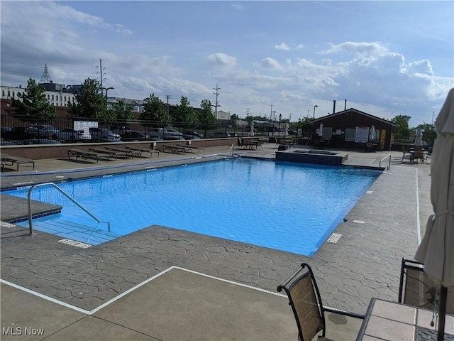 view of swimming pool with a patio area