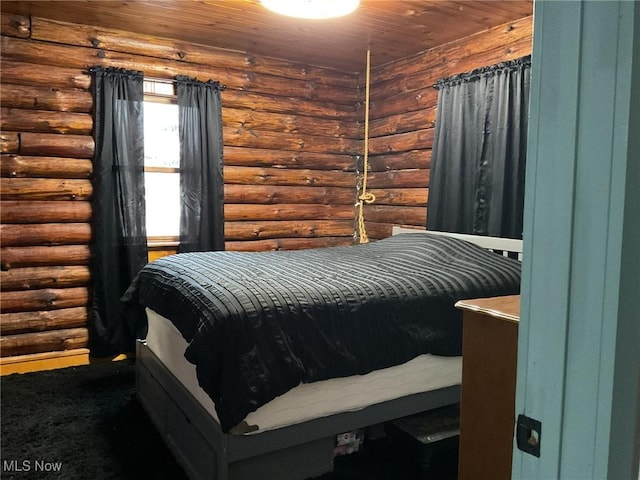 carpeted bedroom featuring wood ceiling