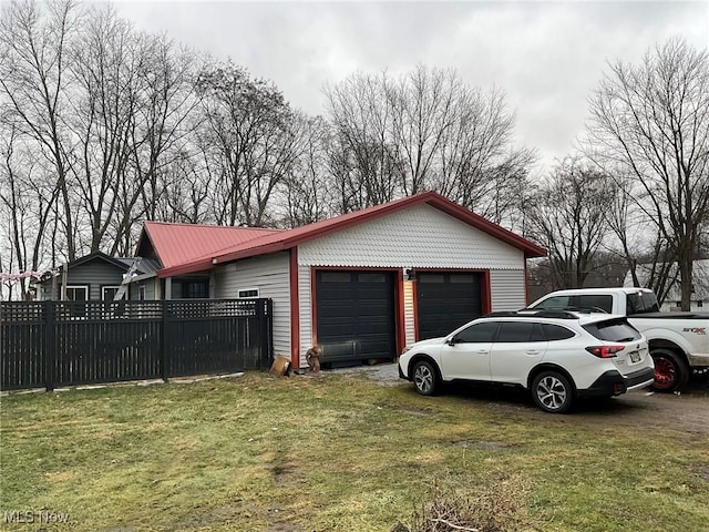 view of property exterior with a garage and a lawn