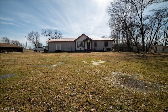 ranch-style house with metal roof and a front yard