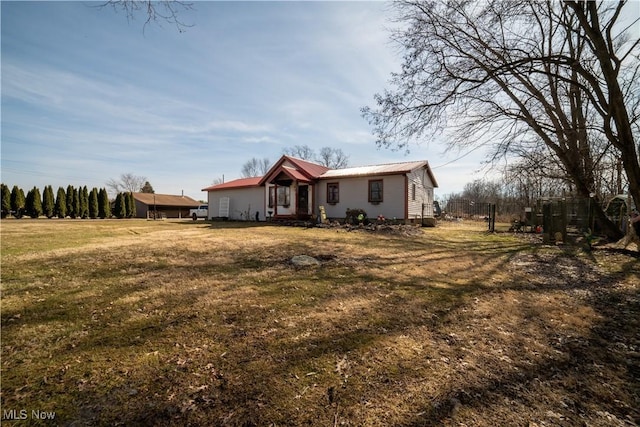 view of front of house with a front yard and metal roof