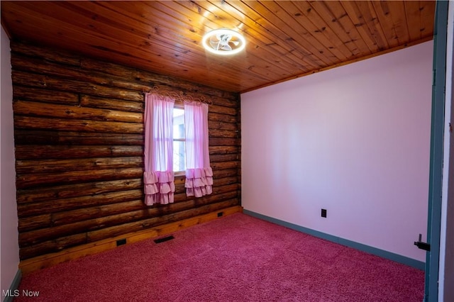 carpeted spare room featuring visible vents, log walls, wood ceiling, and baseboards