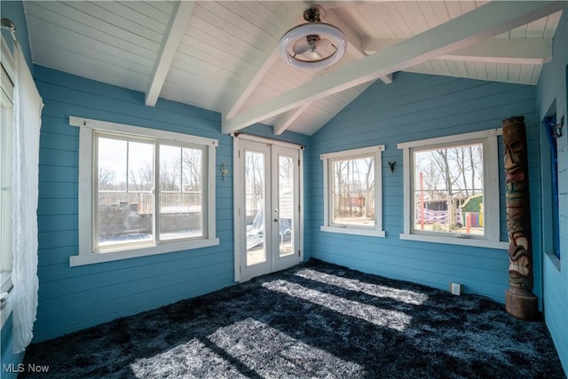 unfurnished sunroom with vaulted ceiling with beams, a wealth of natural light, and french doors