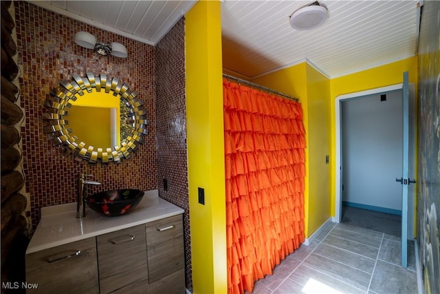 interior space with baseboards, a sink, and tile patterned floors