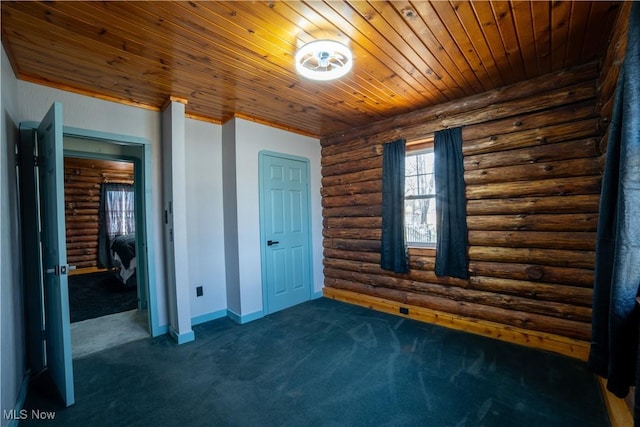 unfurnished bedroom featuring dark carpet, wood ceiling, and baseboards