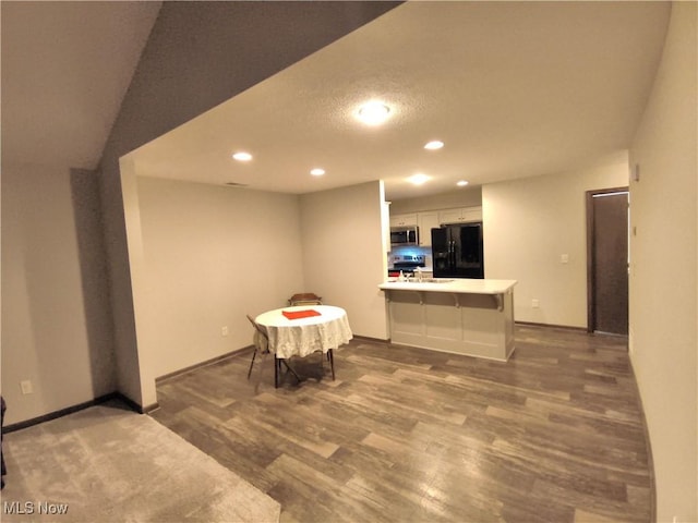 dining area with dark hardwood / wood-style floors, sink, and a textured ceiling