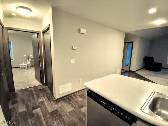 kitchen with sink, stainless steel dishwasher, and dark hardwood / wood-style flooring