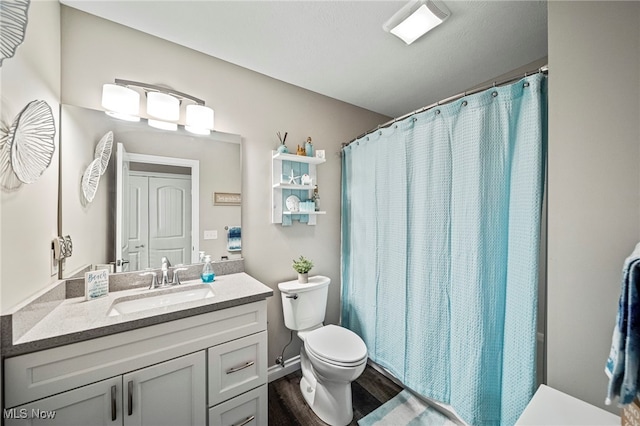 bathroom with vanity, hardwood / wood-style floors, a shower with curtain, and toilet