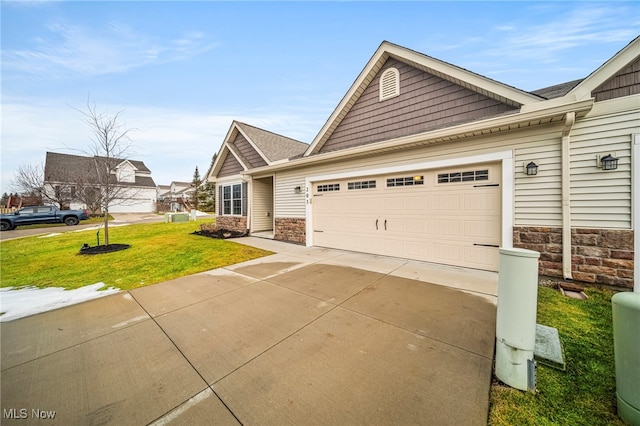 view of front of house with a garage and a front lawn