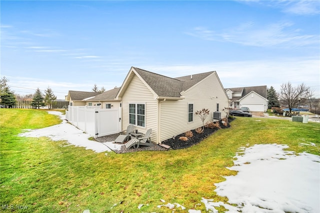 view of home's exterior featuring cooling unit and a lawn