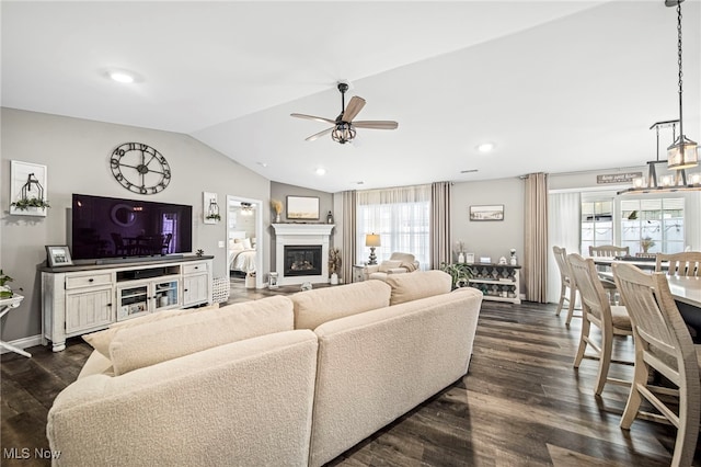 living room featuring vaulted ceiling, ceiling fan, and dark hardwood / wood-style flooring