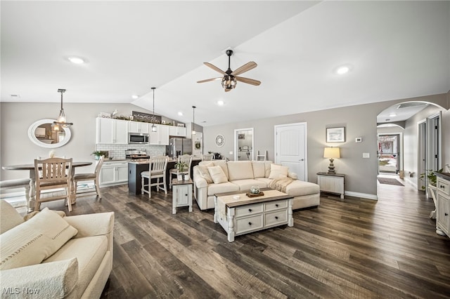 living room with lofted ceiling, dark hardwood / wood-style floors, and ceiling fan