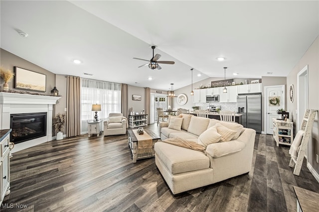 living room featuring ceiling fan, lofted ceiling, and dark hardwood / wood-style flooring