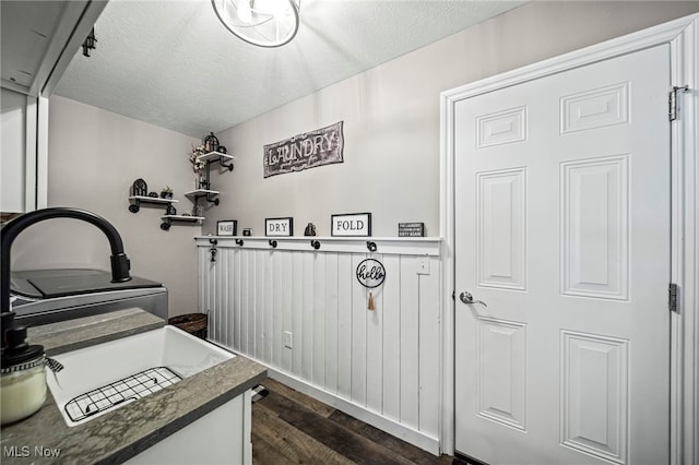 bathroom with hardwood / wood-style flooring and a textured ceiling