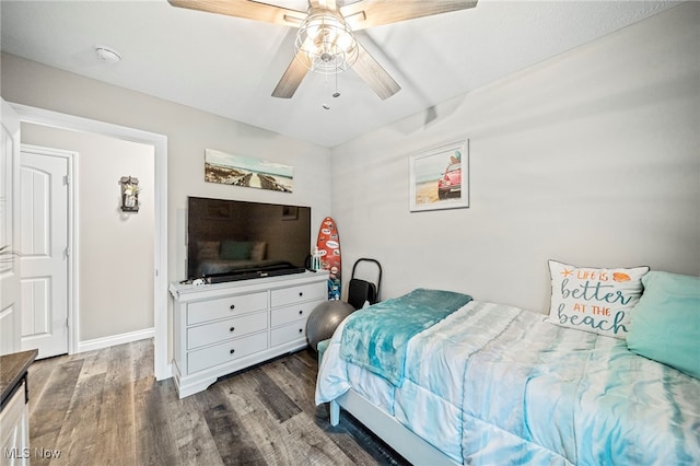 bedroom with ceiling fan and dark hardwood / wood-style flooring