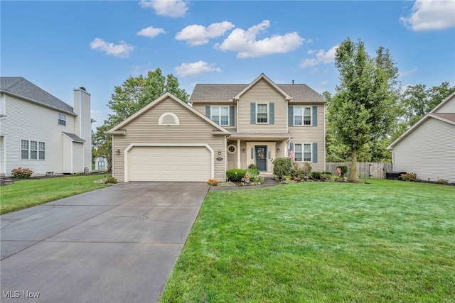 view of front of property featuring a garage and a front lawn