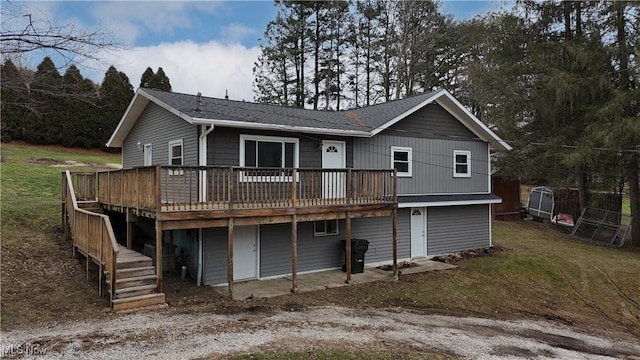 back of house with a wooden deck and a yard