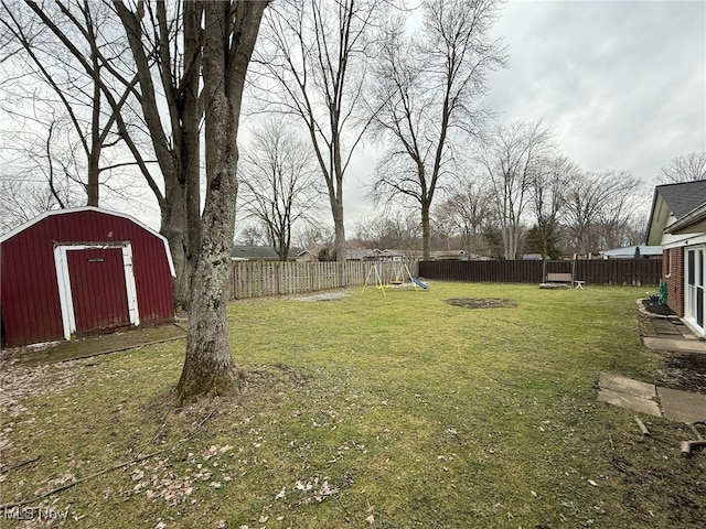 view of yard with a storage unit and a playground