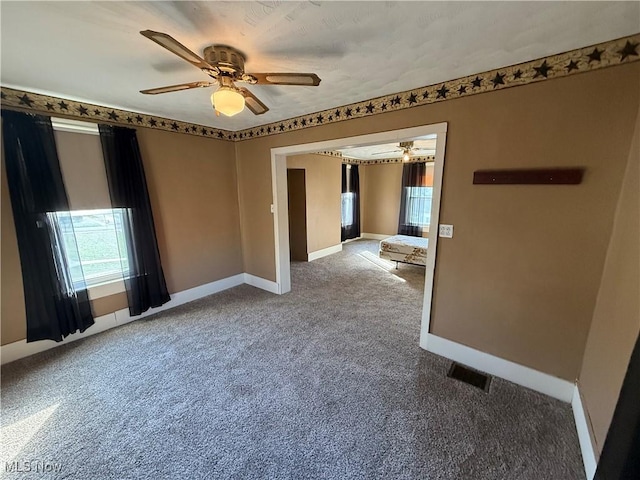 unfurnished room with carpet floors and ceiling fan