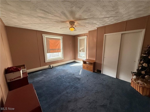 unfurnished bedroom with dark colored carpet