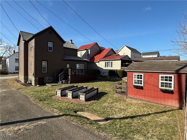 rear view of house with a lawn