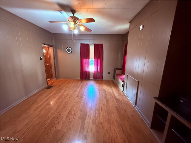 spare room featuring ceiling fan and light hardwood / wood-style flooring